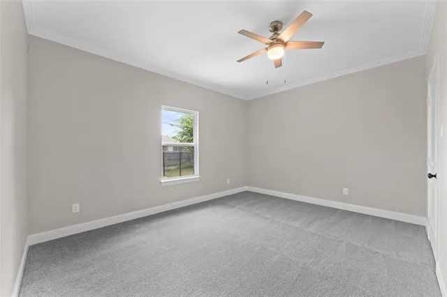 a view of an empty room with a ceiling fan