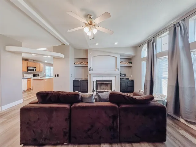 a living room with furniture a fireplace and a chandelier