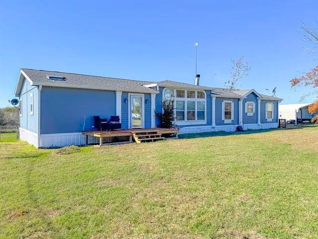 a swimming pool with outdoor seating and yard