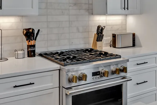 a close view of a stove a microwave and cabinets