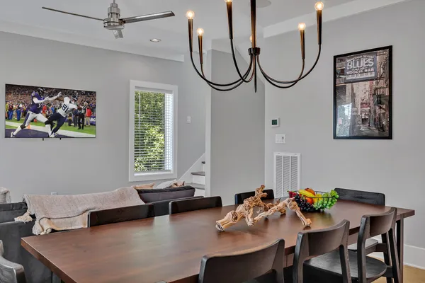 a living room with furniture a window and a potted plant