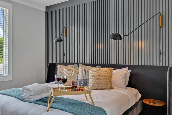 a bedroom with a bed and lamp