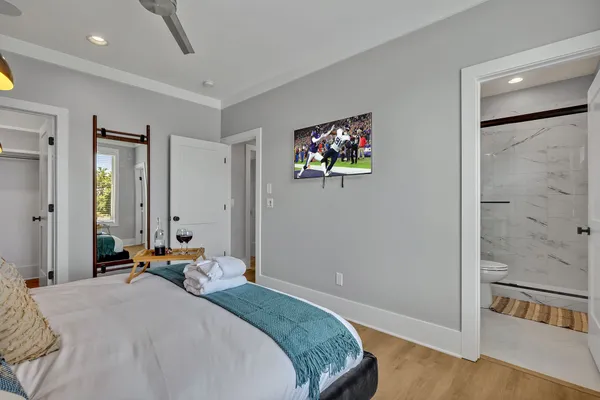 a bedroom with a bed and a flat screen tv
