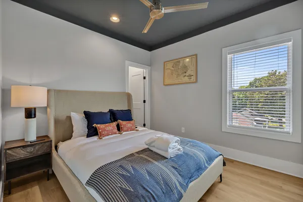 a bedroom with a large bed and a window