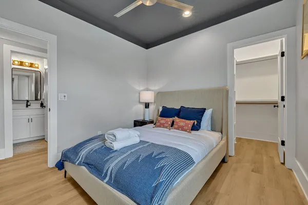 a bedroom with a bed and wooden floor
