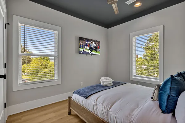 a bedroom with a bed and a window