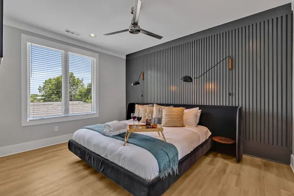 a bedroom with a large bed and a window