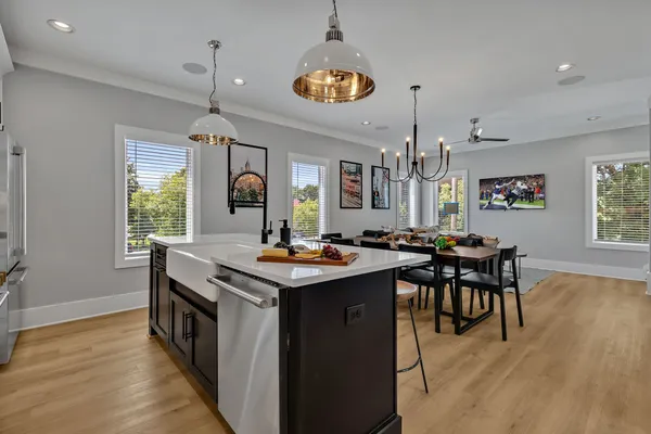 a kitchen with stainless steel appliances granite countertop a stove and a wooden floors