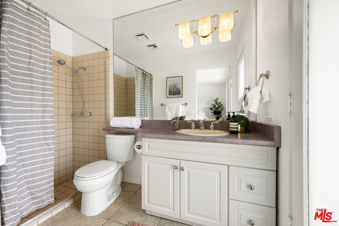 68305 Encinitas Road Cathedral City, CA 92234 - Photo 29 of 33 a bathroom with a toilet a sink and mirror