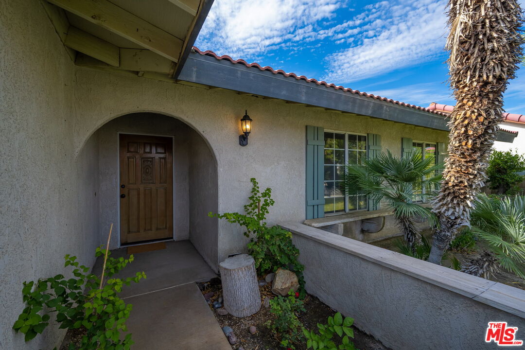 68305 Encinitas Road Cathedral City, CA 92234 - Photo 4 of 33 a front view of a house with potted plants