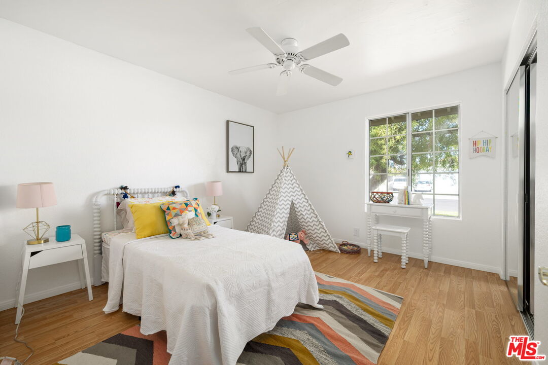 68305 Encinitas Road Cathedral City, CA 92234 - Photo 33 of 33 a bedroom with a bed and wooden floor