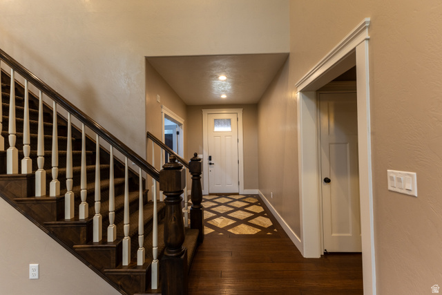 3565 West 1350th Street North Vernal, UT 84078 - Photo 23 of 54 Grand staircase with dark wood-finish treads and white balusters