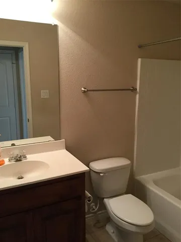 a white toilet sitting next to a bathroom sink