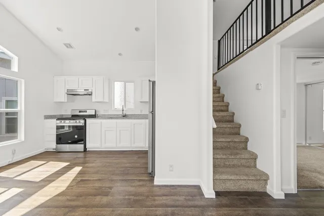 a view of kitchen with sink and cabinets
