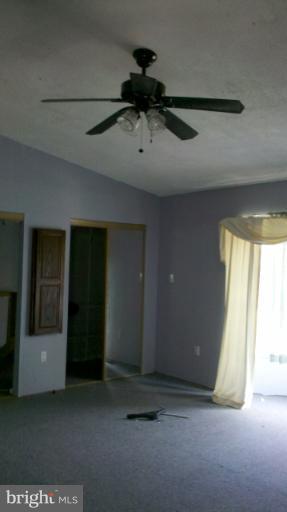 21022 Clarksburg Road Boyds, MD 20841 - Photo 1 of 8 a view of a room with a ceiling fan and window