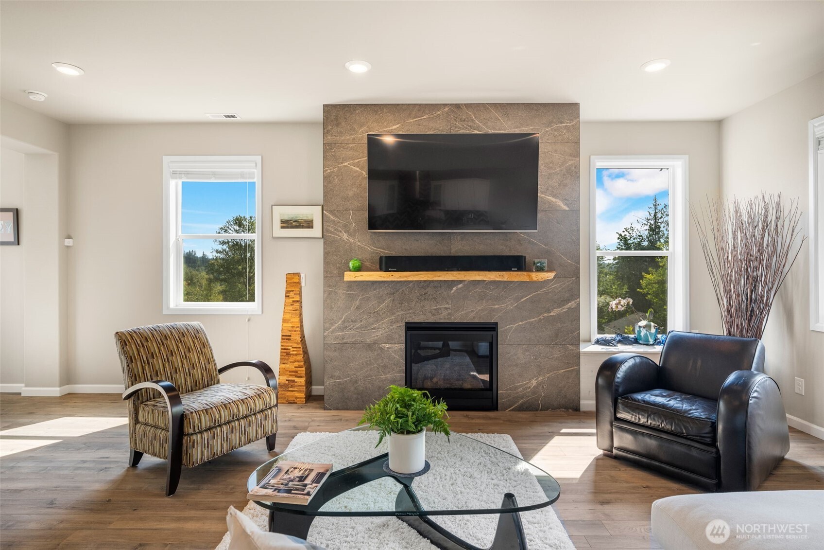 216 178th Street Southeast Bothell, WA 98012 - Photo 7 of 40 a living room with furniture flat screen tv and a fireplace