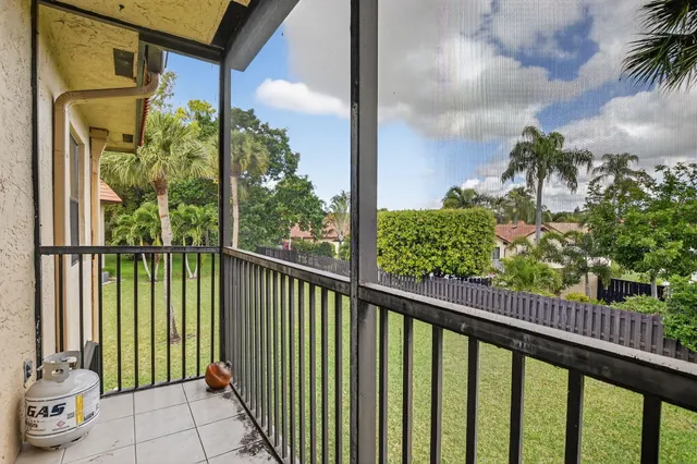 a view of a balcony with potted plants