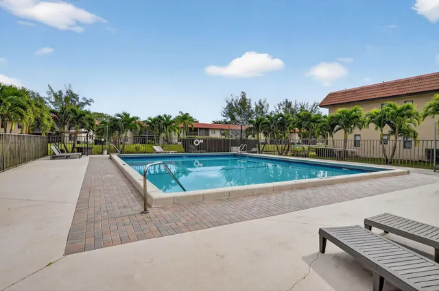 a view of a swimming pool with a yard