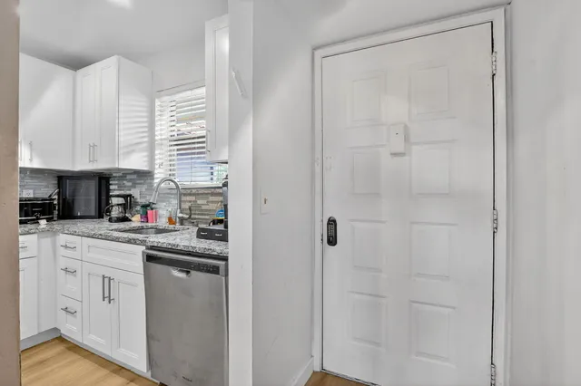 a kitchen with cabinets and window