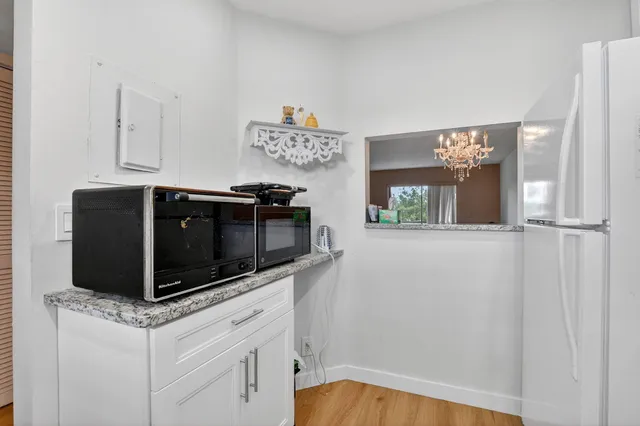 a kitchen with stainless steel appliances granite countertop a stove and a microwave