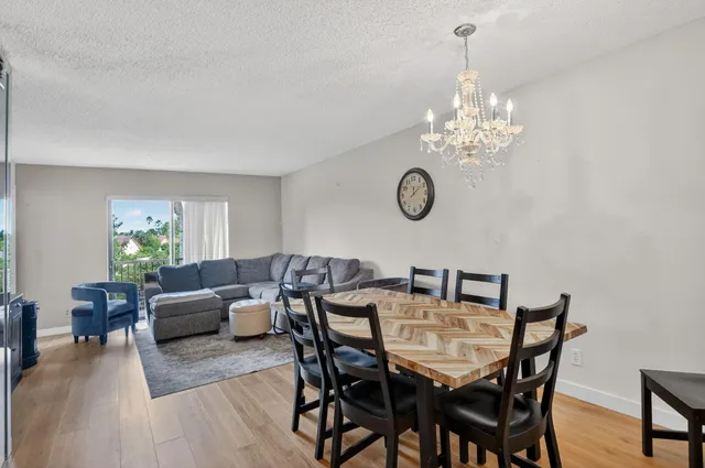 a view of a dining room with furniture wooden floor and chandelier