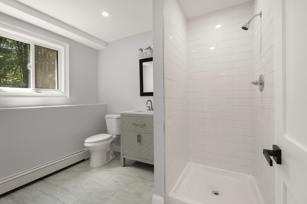 4 Castle Hill Road Windham, NH 03087 - Photo 26 of 42 a bathroom with a toilet a sink and shower