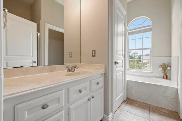 a bathroom with a sink a vanity and a bathtub