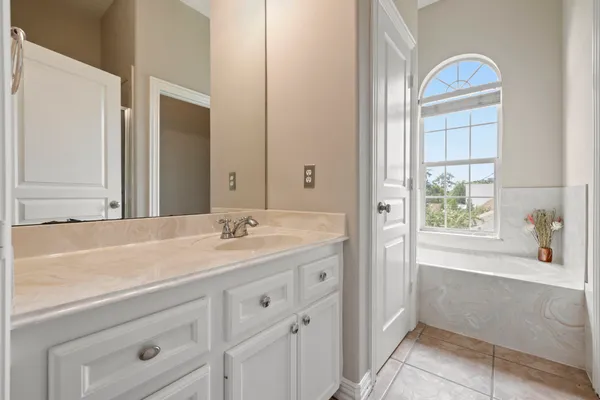 a bathroom with a sink a vanity and a bathtub