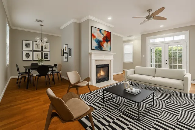 a living room with furniture a flat screen tv and a fireplace