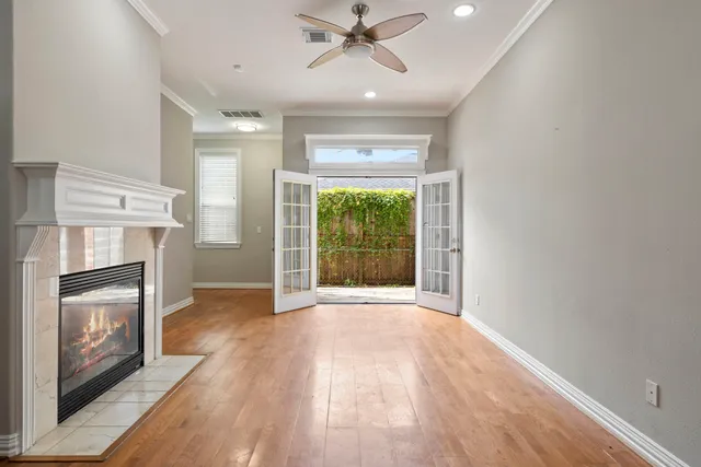 a view of an empty room with a fireplace and a window