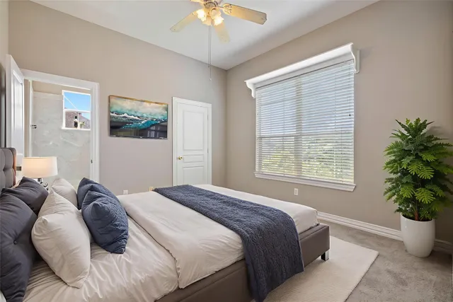 a bedroom with a bed potted plant and a window