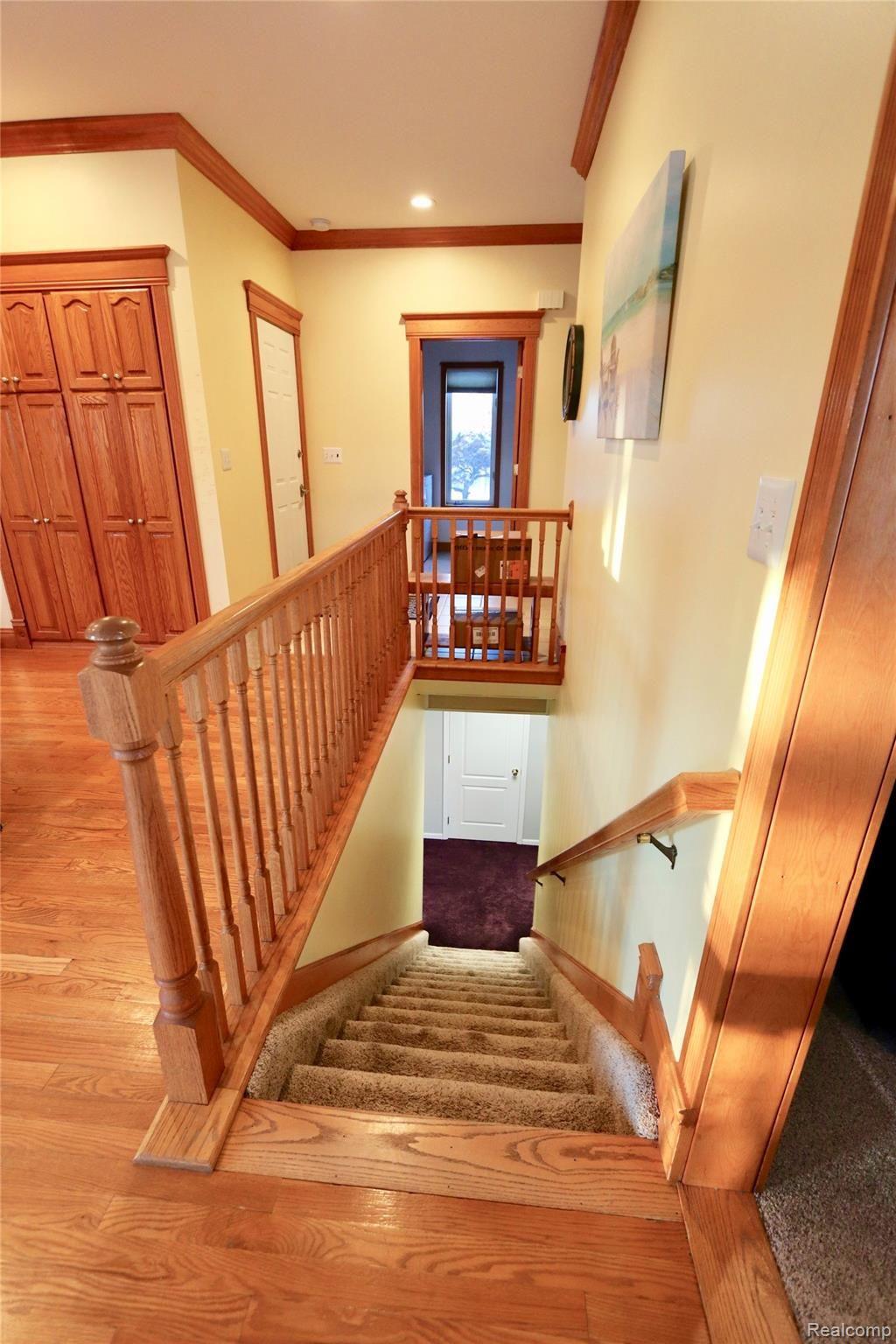 7751 Munsell Road Howell, MI 48843 - Photo 27 of 60 Wood trimmed stairway leading to finished lower level.