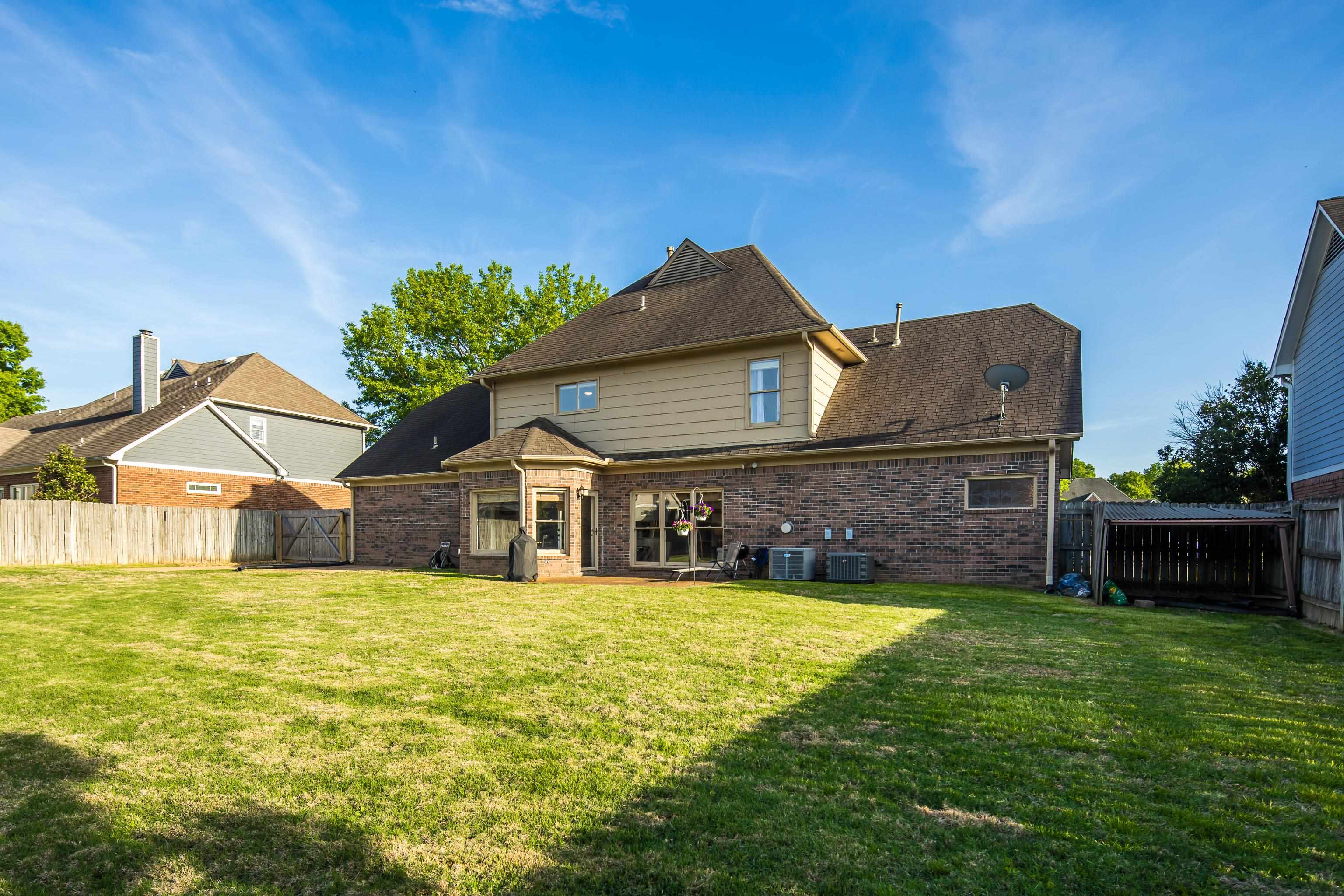 540 Whitney Way Collierville, TN 38017 - Photo 22 of 22 Rear view of property featuring brick siding, a fenced backyard, a gate, and a patio area