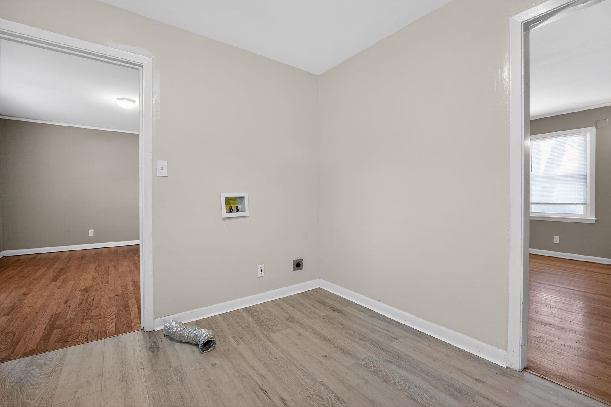 4094 Auburn Road Memphis, TN 38116 - Photo 21 of 30 Laundry room featuring light wood-style floors, electric dryer hookup, and washer hookup