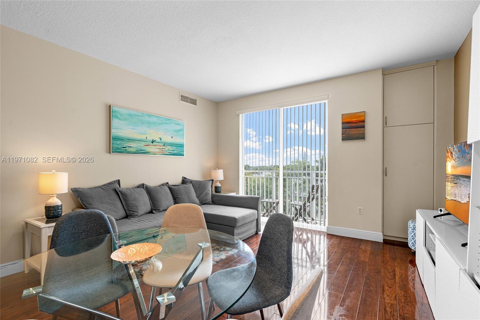 7275 Southwest 90th Way, Unit 404 Miami, FL 33156 - Photo 9 of 35 a living room with furniture and a flat screen tv