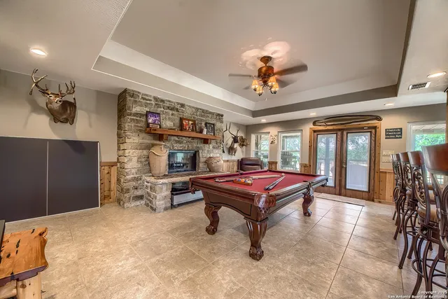 a living room with furniture a flat screen tv and a chandelier