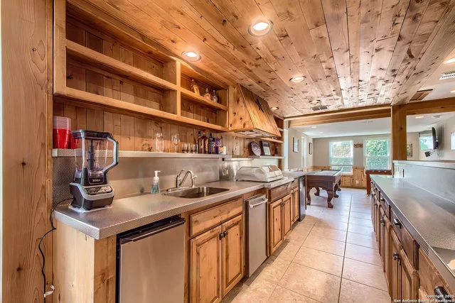 a kitchen filled with stainless steel appliances granite countertop a sink and cabinets