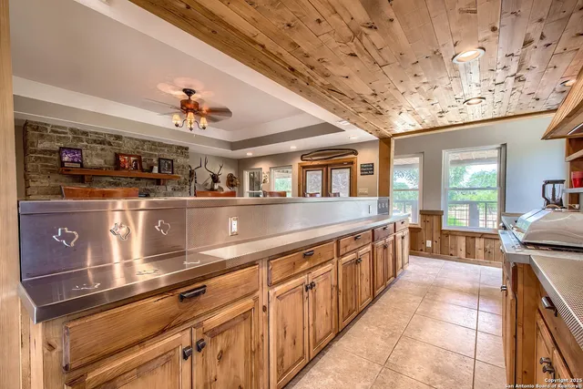 a large kitchen with stainless steel appliances granite countertop a large stove a sink and dishwasher