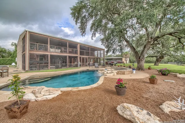 a view of a house with backyard porch and sitting area
