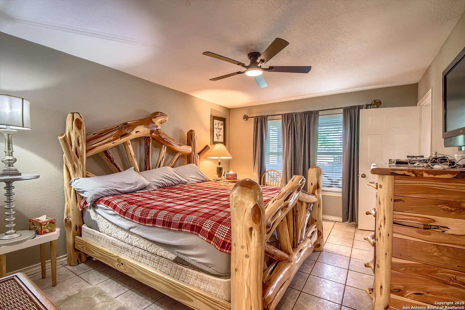 5464 Coughran Road Pleasanton, TX 78064 - Photo 29 of 55 a bedroom with a bed and a chandelier