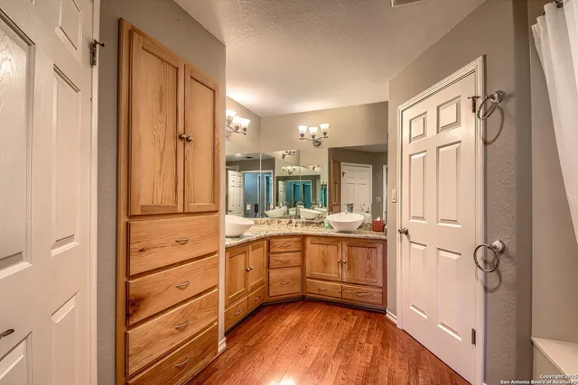 a bathroom with a granite countertop sink mirror and a bathtub