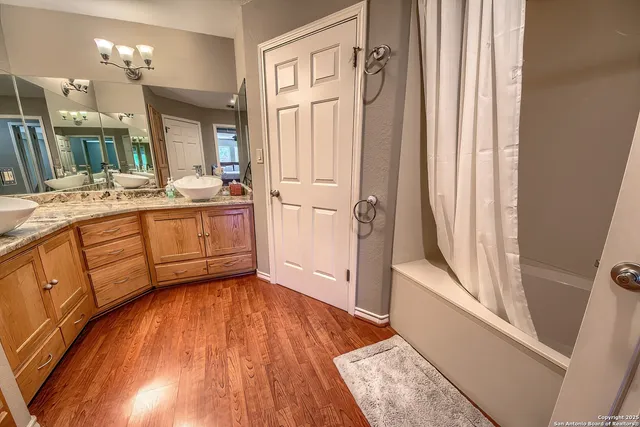 a bathroom with a sink a mirror and a bathtub