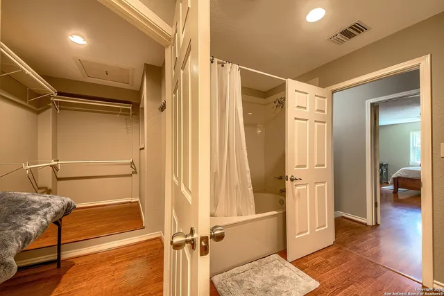 a bathroom with a shower and a glass door