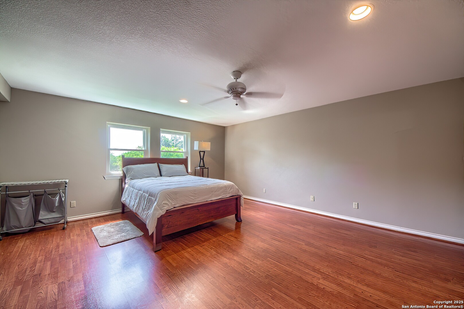 5464 Coughran Road Pleasanton, TX 78064 - Photo 39 of 55 a spacious bedroom with a bed and a table in it
