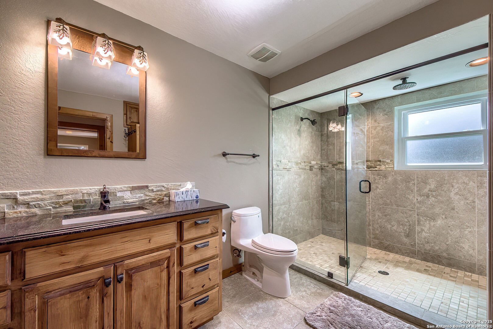 5464 Coughran Road Pleasanton, TX 78064 - Photo 43 of 55 a bathroom with a sink a toilet and shower