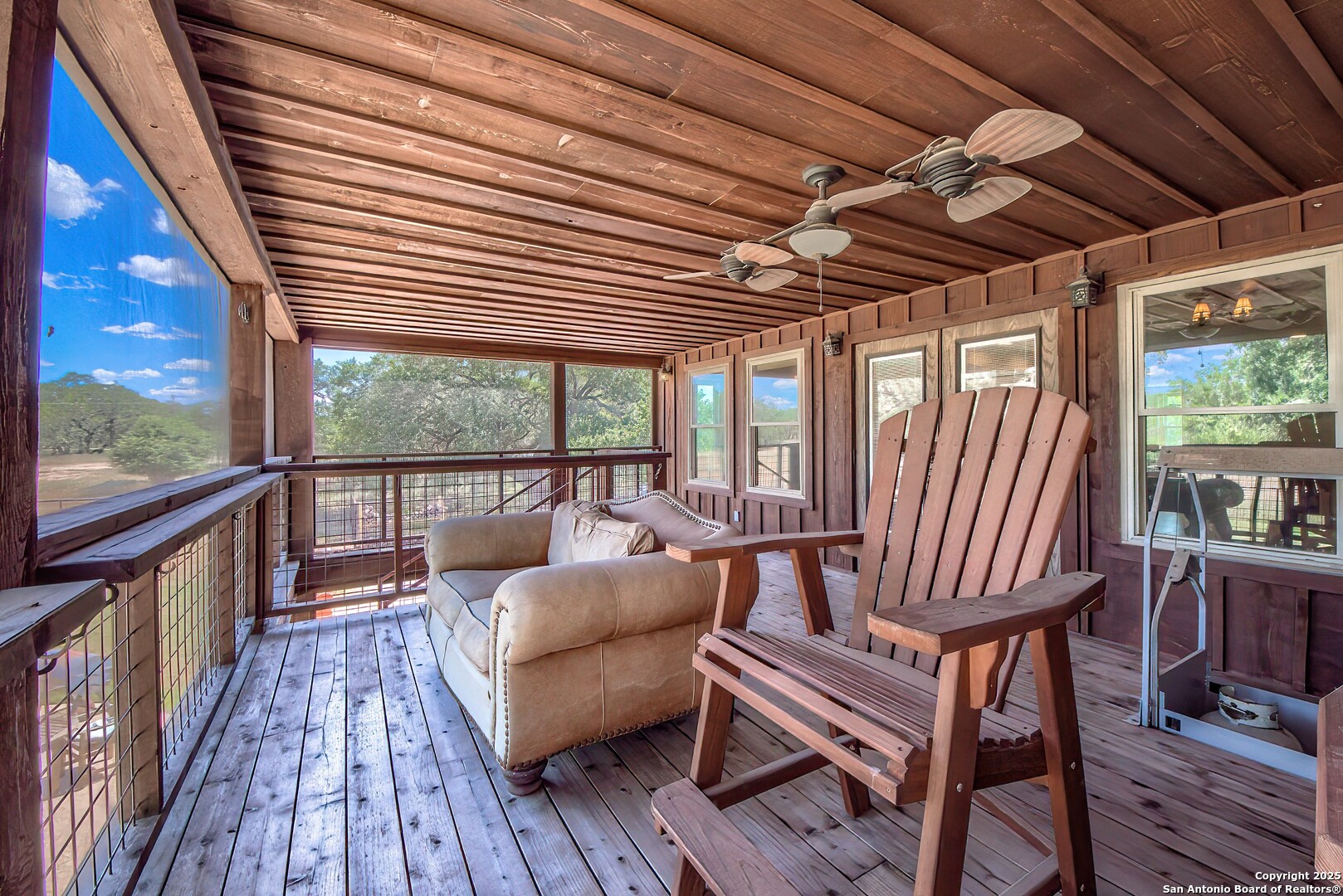 5464 Coughran Road Pleasanton, TX 78064 - Photo 45 of 55 a view of a balcony with furniture and wooden floor