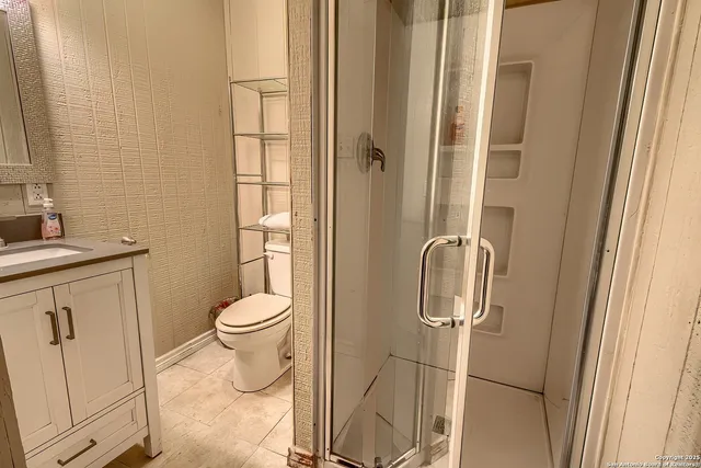 a kitchen with stainless steel appliances granite countertop a refrigerator a stove and a sink