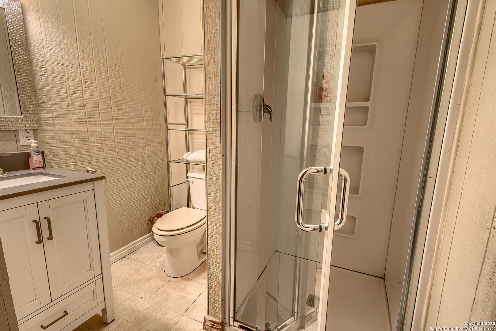 5464 Coughran Road Pleasanton, TX 78064 - Photo 48 of 55 a bathroom with a granite countertop toilet sink and shower