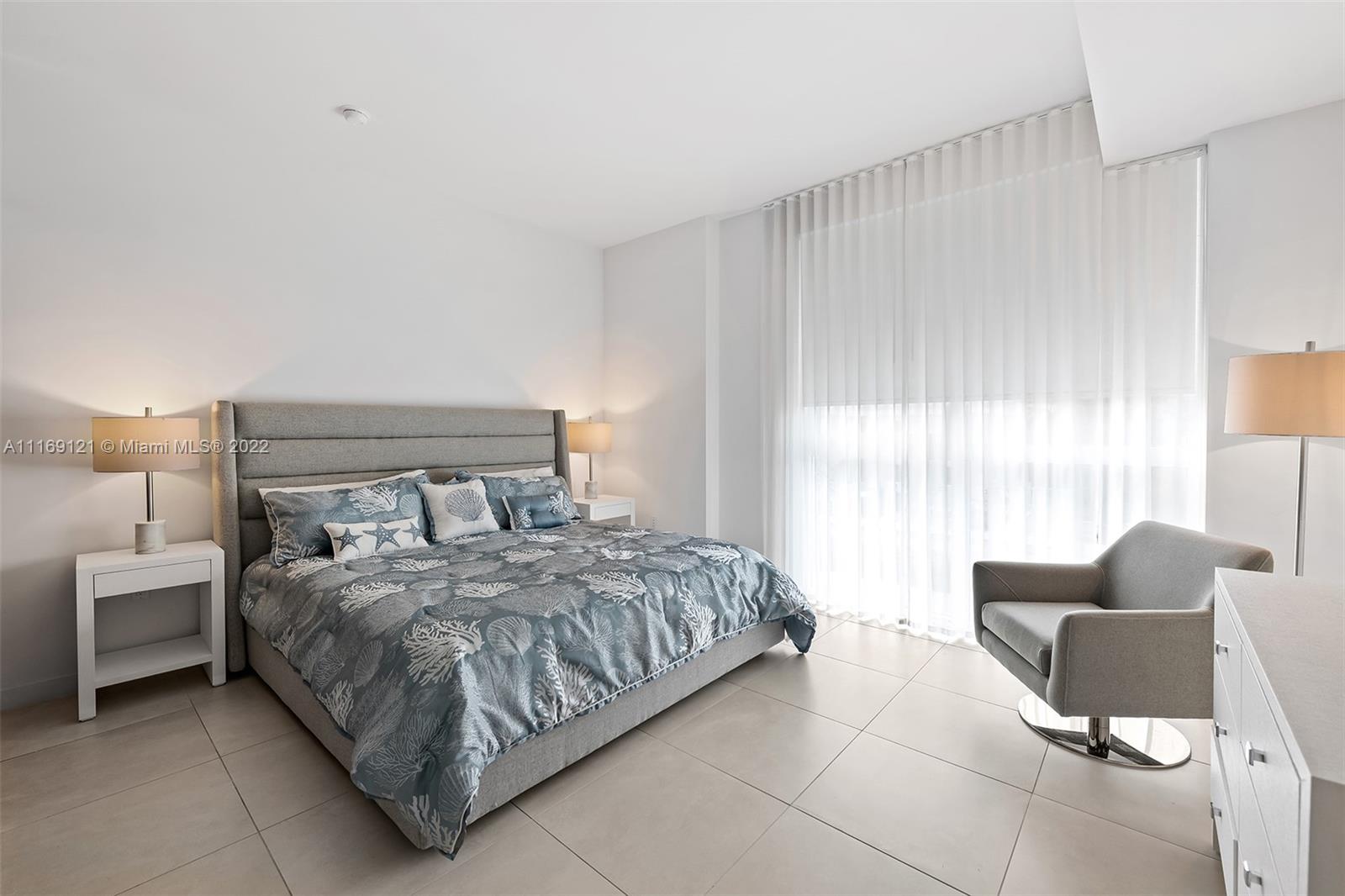 401 North Birch Road, Unit TH7 Fort Lauderdale, FL 33304 - Photo 12 of 29 a bedroom with a bed and a couch
