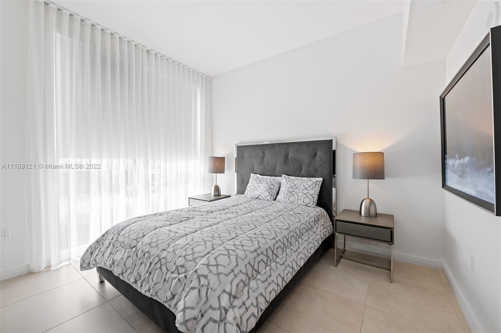 401 North Birch Road, Unit TH7 Fort Lauderdale, FL 33304 - Photo 15 of 29 a bedroom with a bed and window